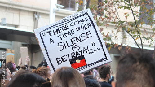 Sydney, NSW / Australia - June 6 2020: Black Lives Matter March. Protesting Aboriginal deaths in custody and the death of. A sign reading 'there comes a time when silence is betrayal'. photo