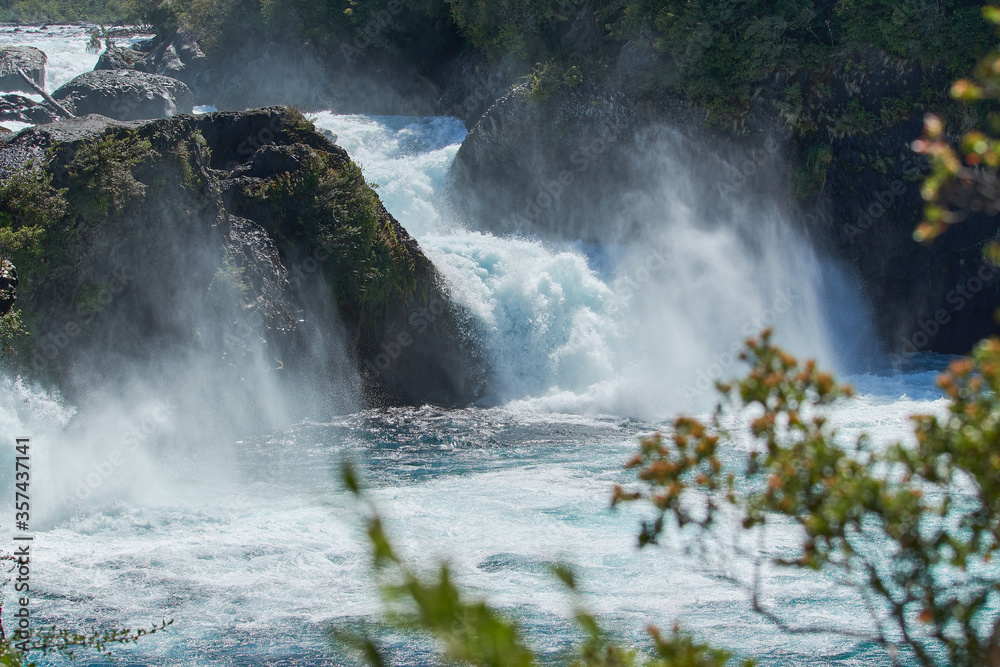 PETROHUE, CHILE - FEBRUARY 11, 2020: The waterfalls, rapids and tourists of Petrohue on a sunny day in the lake region of Chile, near of Puerto Varas. Turquoise water.