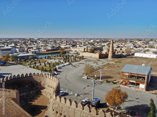 Panoramic view on west part of Khiva, Uzbekistan, from wall of citadel Itchan Kala. There is square before fortress, part of wall and Bikajon Bika Mosque. All city included in UNESCO Heritage List
