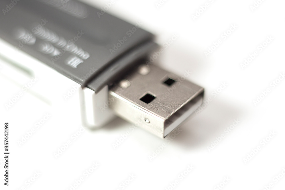 Flash memory card reader USB, isolated on white background. Macro, selective focus. Flash memory card reader USB, isolated on white background. Macro, selective focus.