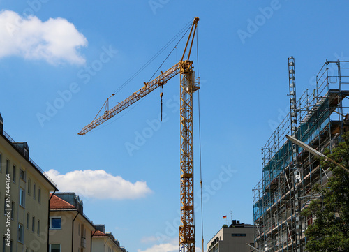 Munich, Germany, June 2020 : A construction crane at a construction site on a lovely summer day. 