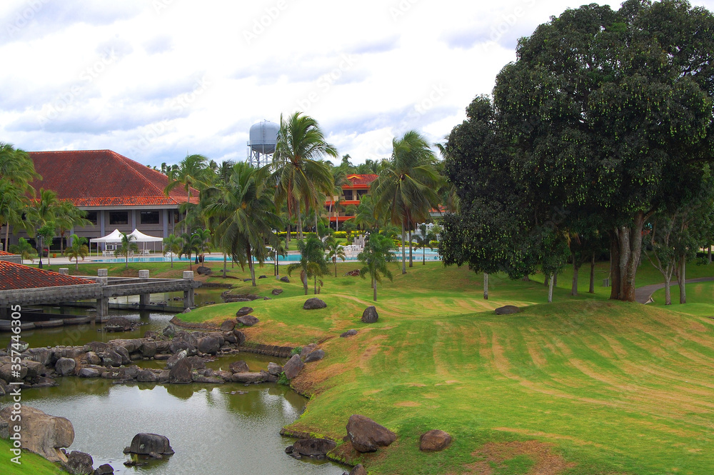 Conference hall facade surrounded with lake, trees, and golf course at Mount Malarayat in Lipa, Batangas, Philippines