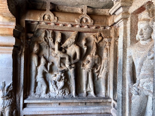 Bas relief rock cut sculptures of gods, people and animals are carved prominently in the monolithic cave temples at Mahabalipuram, Tamil nadu, India photo