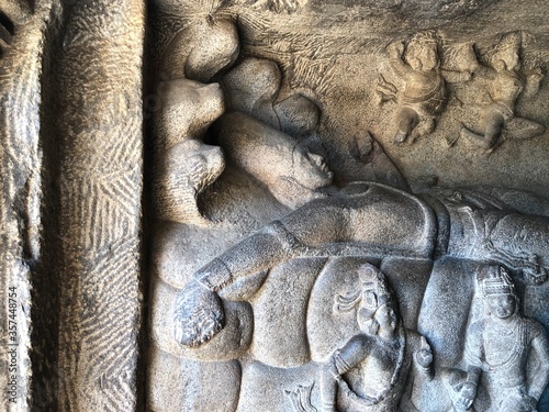 Bas relief rock cut sculptures of gods, people and animals are carved prominently in the monolithic cave temples at Mahabalipuram, Tamil nadu, India photo
