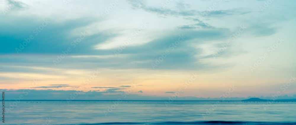 beautiful clouds over the sea. seascape, natural minimalistic background and texture, panoramic view banner. Orange and blue pastels tones