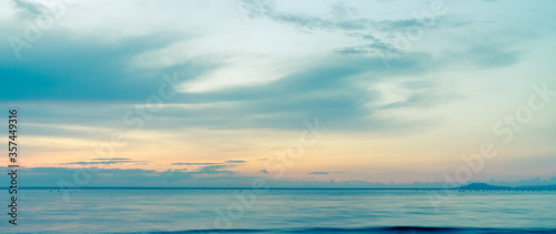 beautiful clouds over the sea. seascape, natural minimalistic background and texture, panoramic view banner. Orange and blue pastels tones