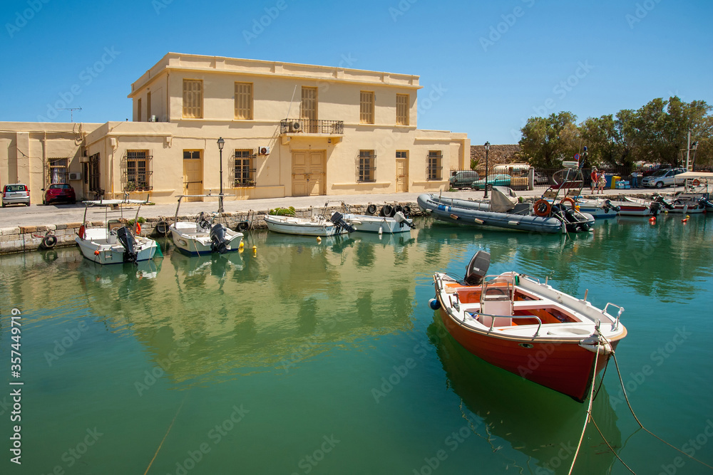 Boat in the harbor of the port on the background of houses