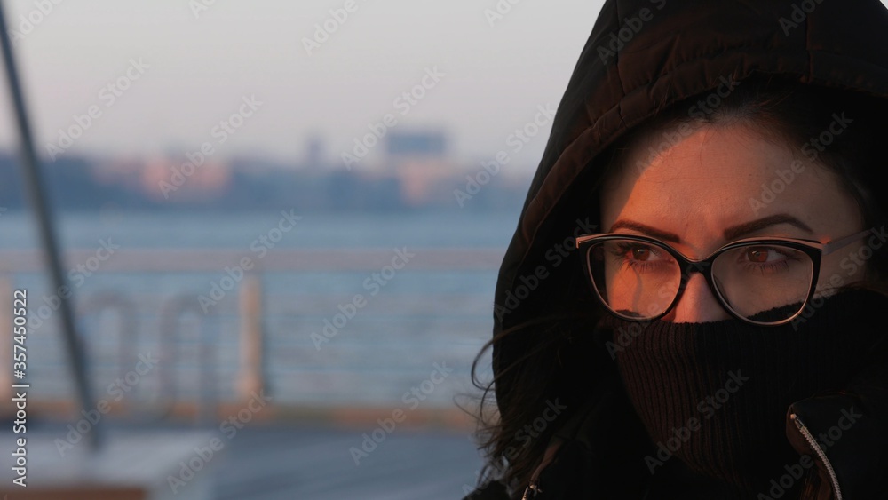 Misterious young woman watching the sunset in New York City