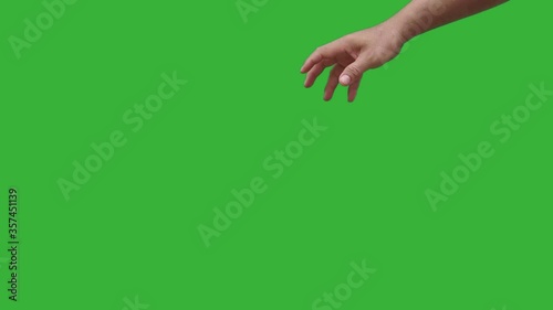 Footage real time human hand gently dropping trash paper isolated on chroma key green screen background. 