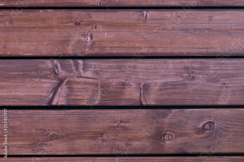 Background made of dark old-fashioned piece of wood. Unpainted blank background with horizontal stripes with copy space.