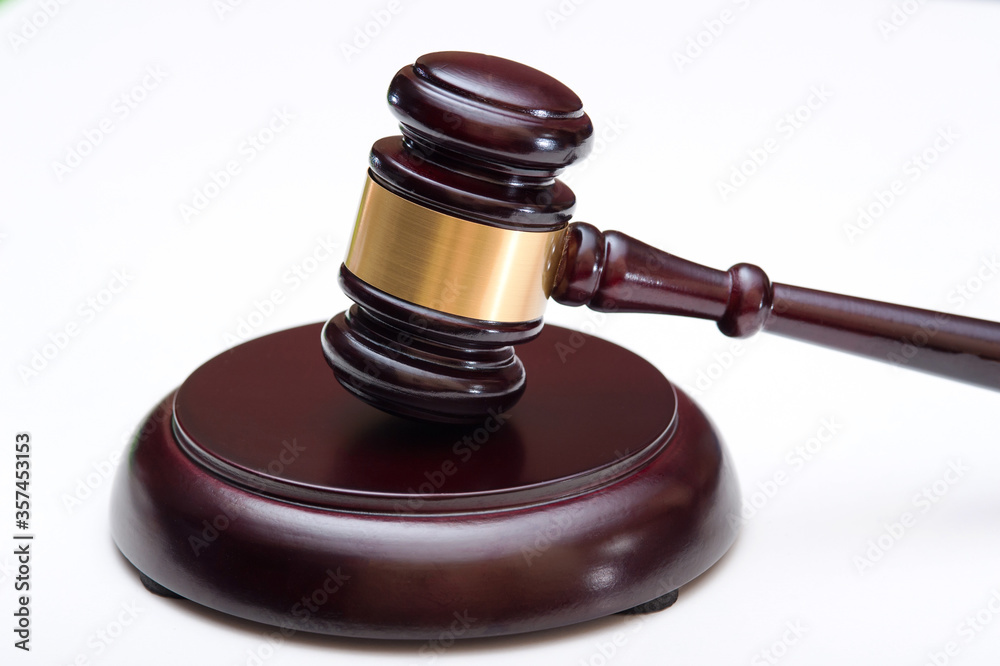 Wooden judge's hammer with a metal ring and soundboard isolated on a white background. Wooden judge's hammer with a metal ring and soundboard isolated on a white background.