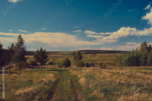 Landscape of central Russia agricultural countryside with  country road. Summer landscape of the Samara valleys. Russian countryside.