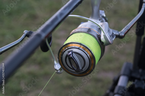 Fishing rods closeup. Carp reels on a stand in a pond