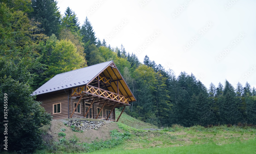 Wooden summerhouse standing in the middle of the woods