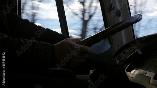 Side view of bus or van dashboard and driver's hands on steering wheel when driving motorway or rural road in europe or northern america concept profession truck driver cargo and passenger transporta