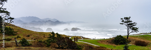 Ecola State park on a rainy winter day with Canon Beach and Haystack Rock in the background. photo