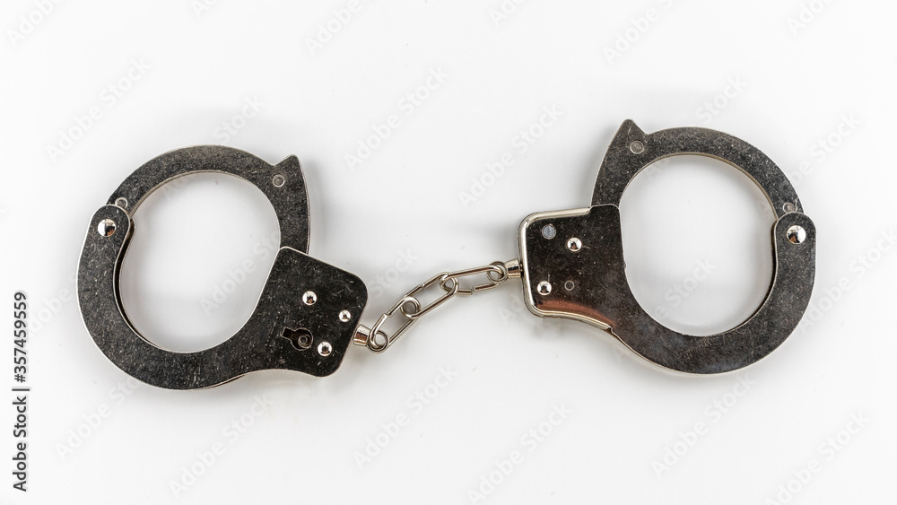 metal handcuffs on a white background, isolates metal handcuffs on a white background, isolates