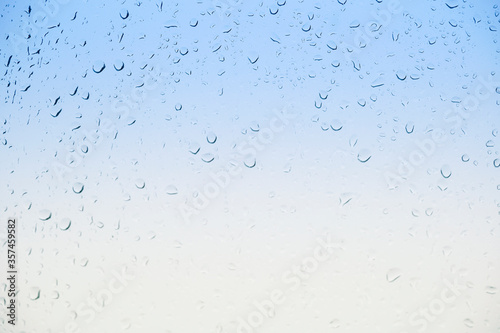 Water drops on glass, gradient background. High quality photo
