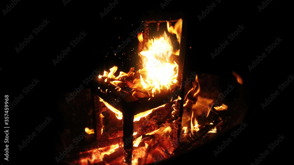 Wooden chair burning inside the bonfire Wooden chair burning inside the bonfire