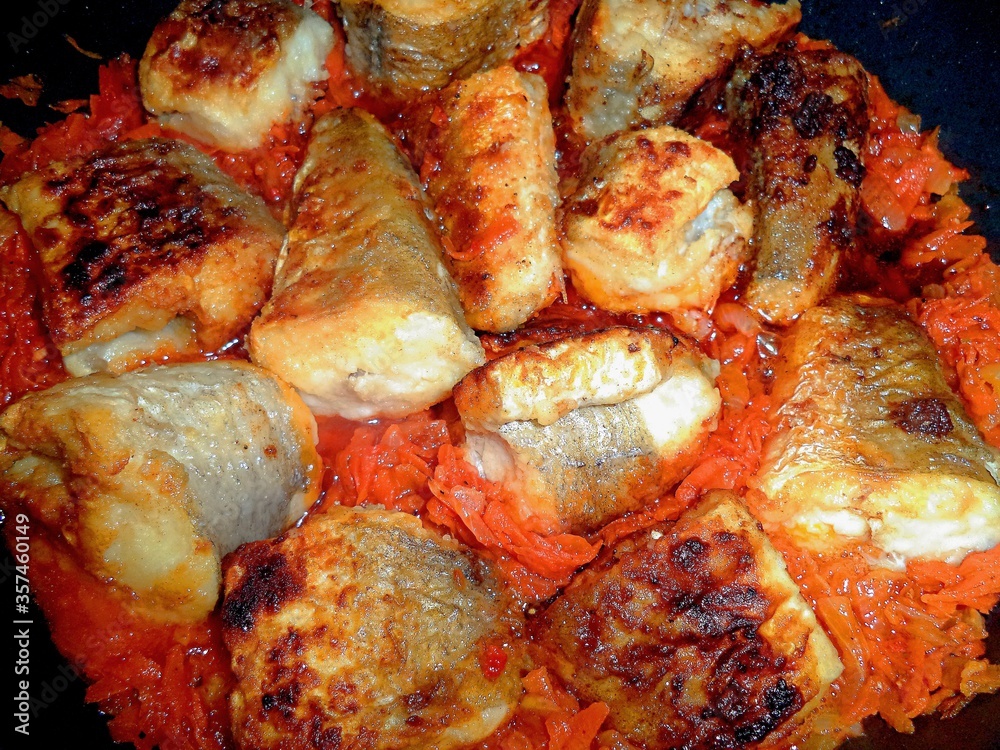 fried fish slices with vegetables in tomato