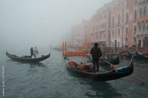 Gondolier floats on the Grand Canal in foggy weather © Ambasada Studio