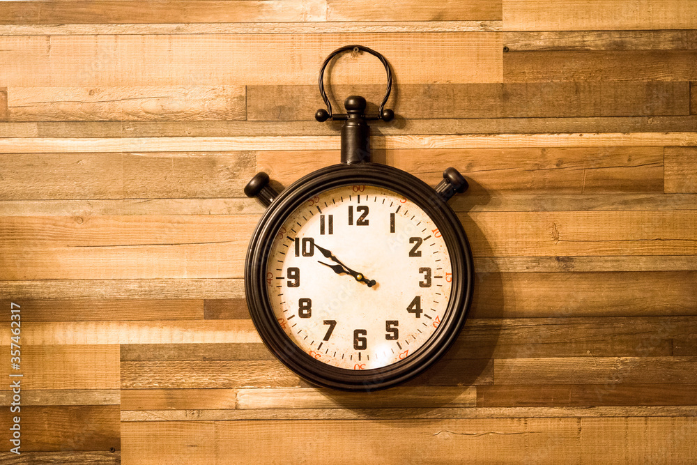 Old authentic clock hanging on a wooden wall. Old authentic clock hanging on a wooden wall.