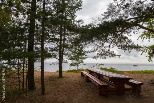 On the shore of lake - comfortable wooden benches.