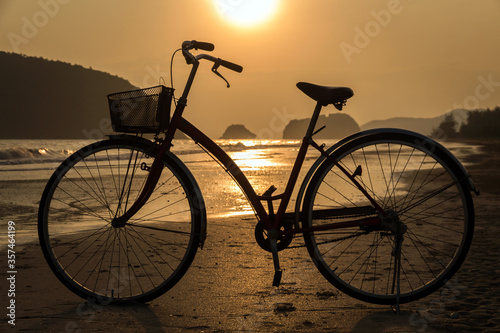 silhouette of bicycle at beach, bicycles on beach sunset or sunrise