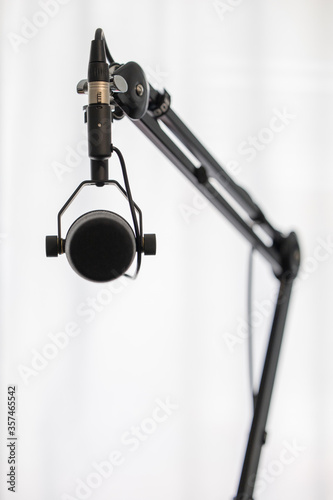Black microphone on arm with white background