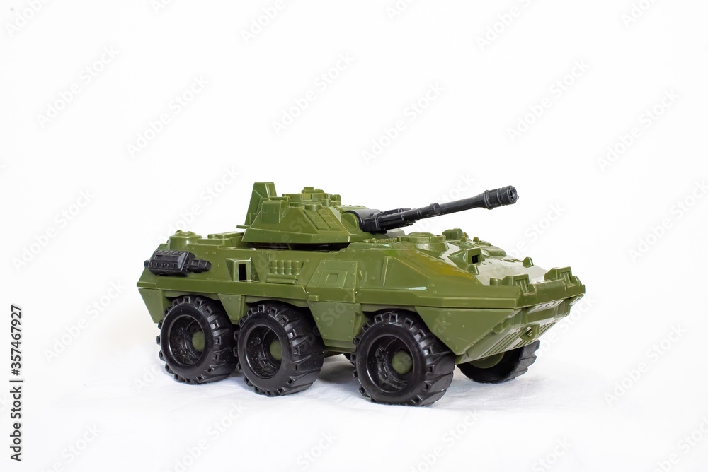A toy model of an armored car is turned sideways on a white background