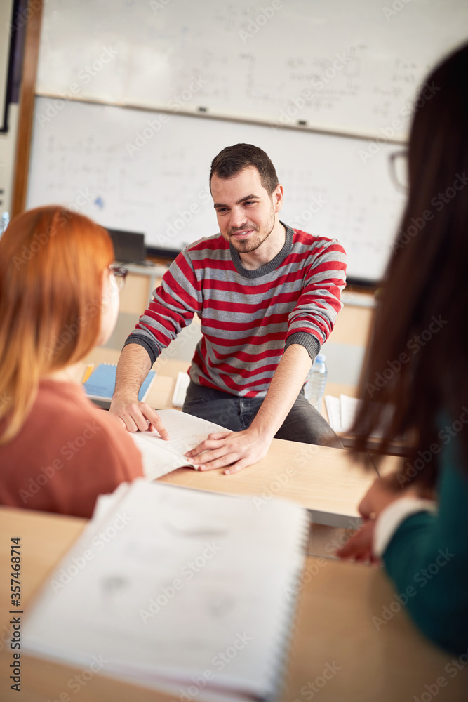 Naklejka premium Male colleague helping female classmate