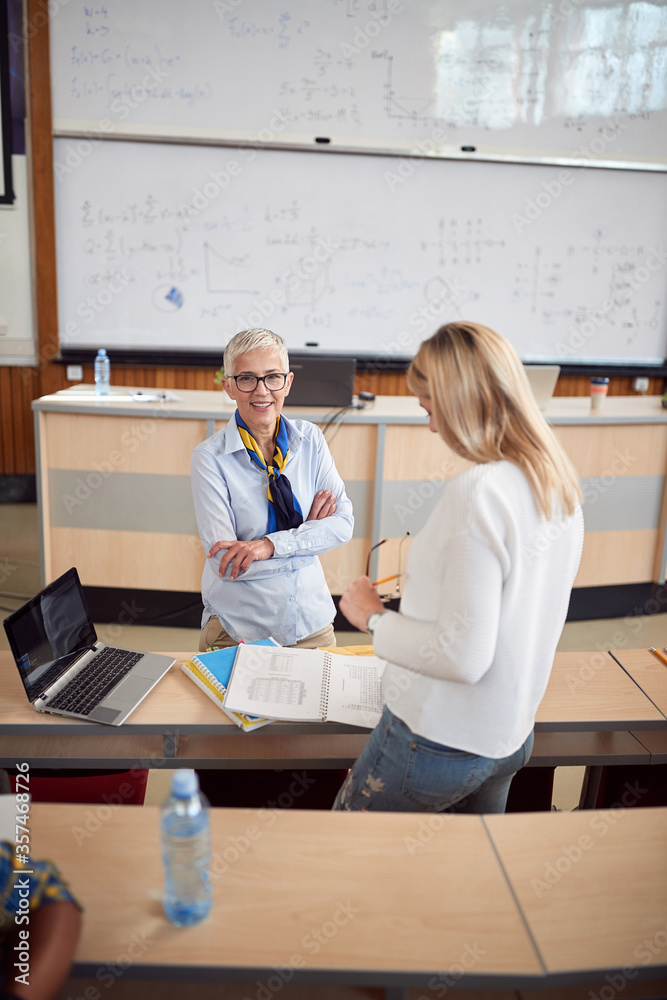 Elderly female professor questioning a student Elderly female professor questioning a student