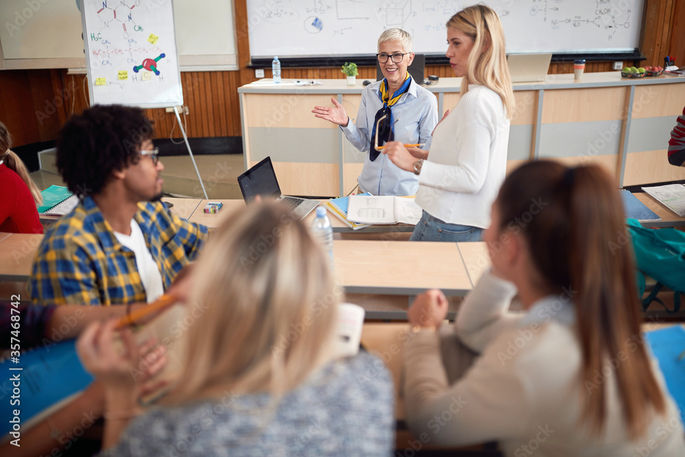 Elderly female professor questioning a student Elderly female professor questioning a student