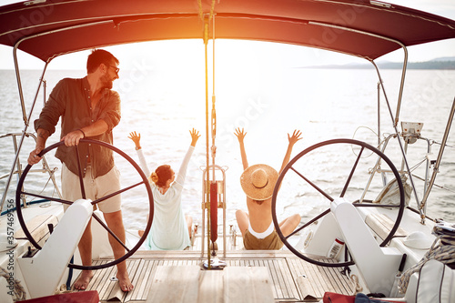 Man with womans on the boat enjoy on summer day and traveling