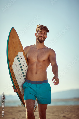 Photography Young man going to surfing on the beach
