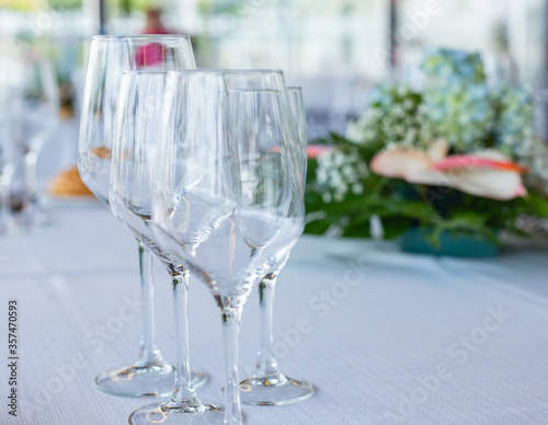 Empty crystal or glass cups on a tablecloth