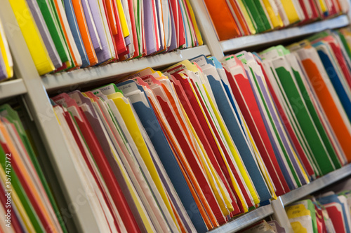 Close-up of multi colored files on shelf at office