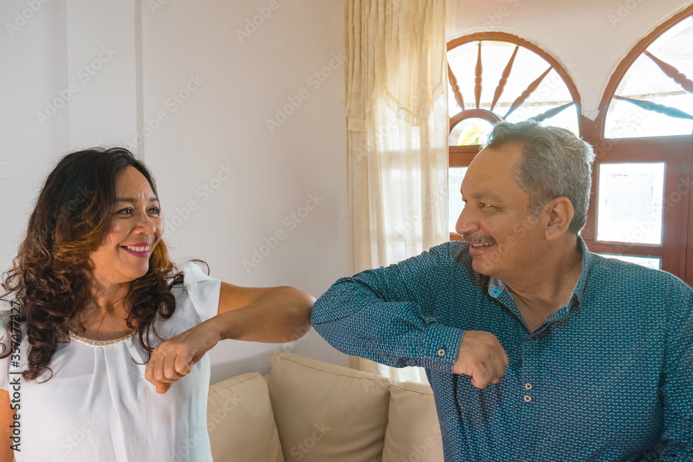 Obraz premium Smiling couple elbowing in the workplace, health care concept