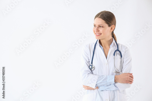 Portrait of young doctor against white background