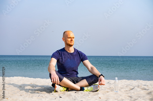 Young male athlete meditation outdoors in sunny day © serejkakovalev