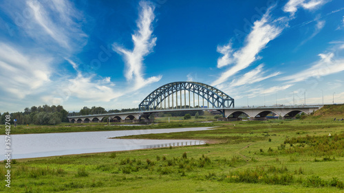 Large blue car traffiic IJssel bridge crossing the river IJssel in Zwolle, Overijssel in The Netherlands.View from park Het Engels werk. photo