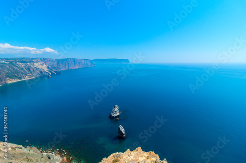Rocks in turquoise water. Against the background of a rocky lagoon. Cape Fiolent.