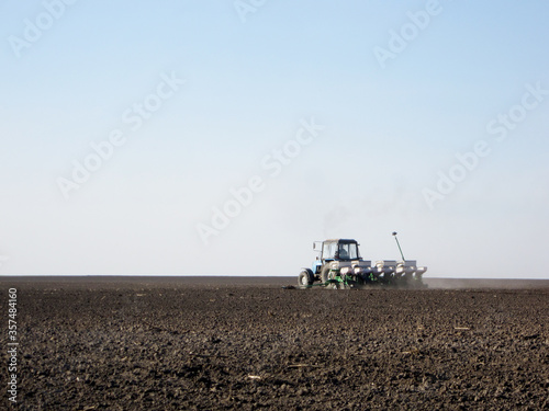 Obraz na plátně Plowed field by tractor in brown soil on open countryside nature