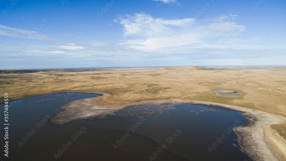 Countryside scenic. Aerial view of the golden prairie, coastline and lake in autumn.