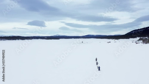 Sami people are dog sledding on the frozen Torne River. Kiruna.