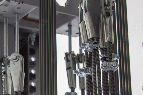 Elements of fastening steel cables in the glass shaft of the elevator.