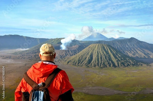 Man stay on the top near volcano Bromo in Indonesia