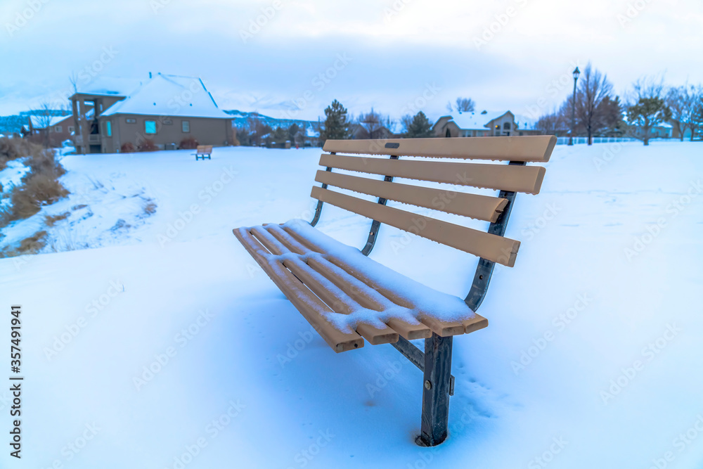 Picturesque snow covered landscape in winter with empty bench by the Utah Lake