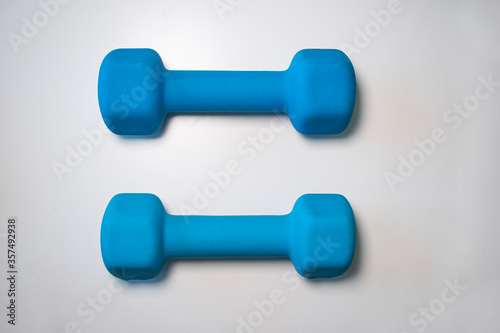 Two blue dumbbells isolated on white 
