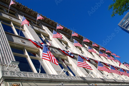 many American flags at facade of building